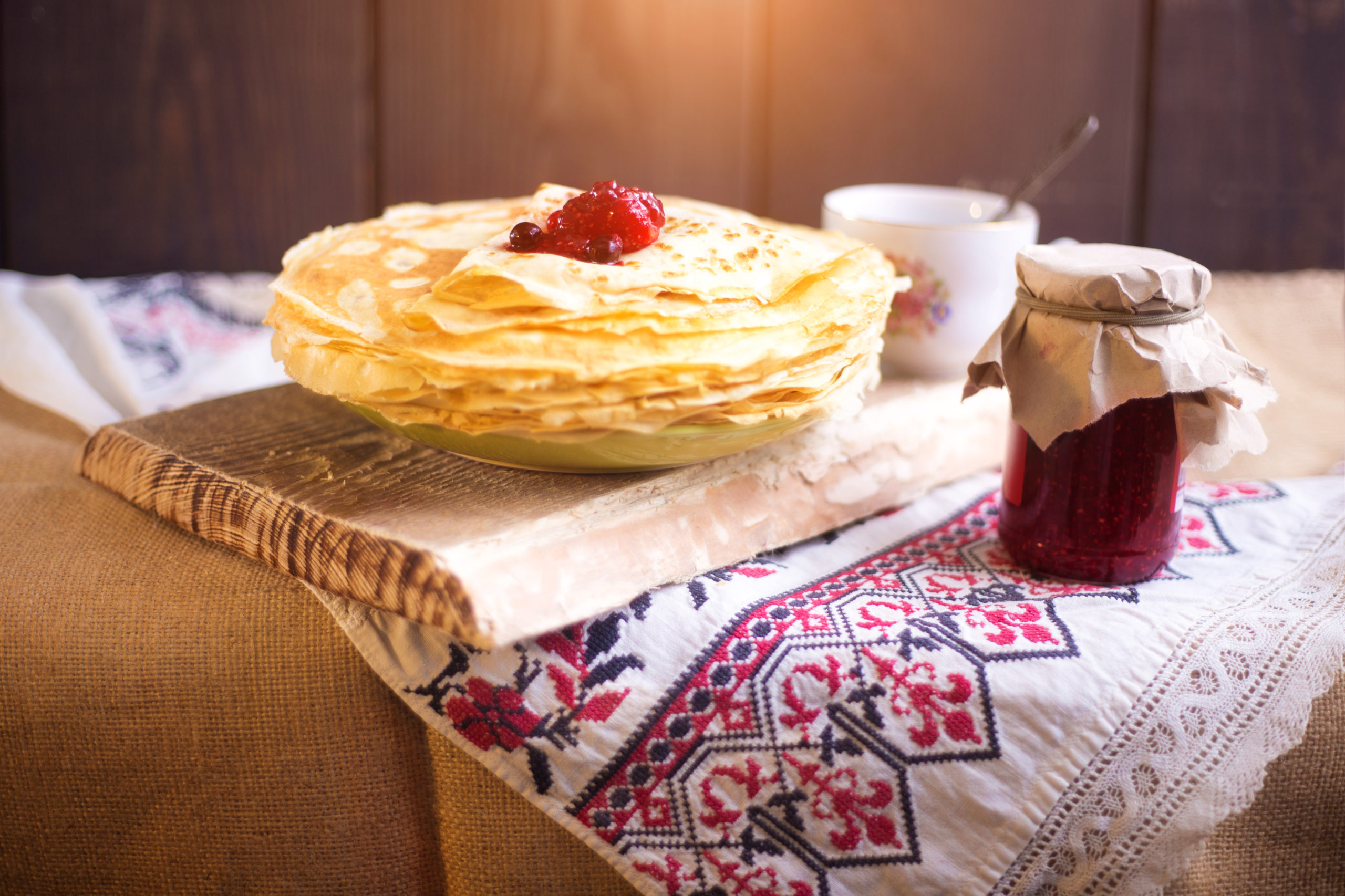 Homemade hot pancakes with jam. Rustic style, crepes closeup.