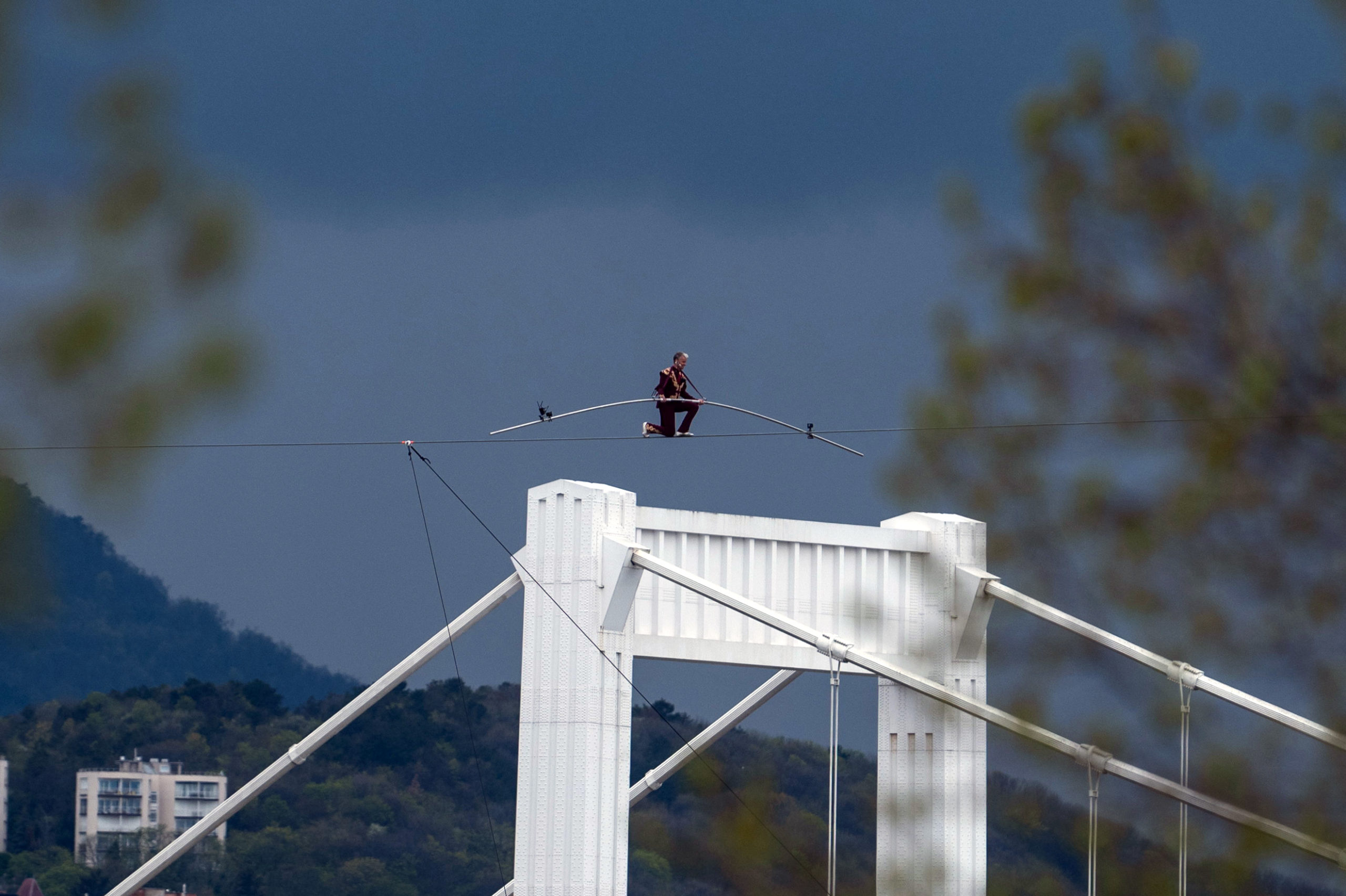 Acrobat Laszlo Simet walks on a wire rope to mark the World Circus Day in Budapest